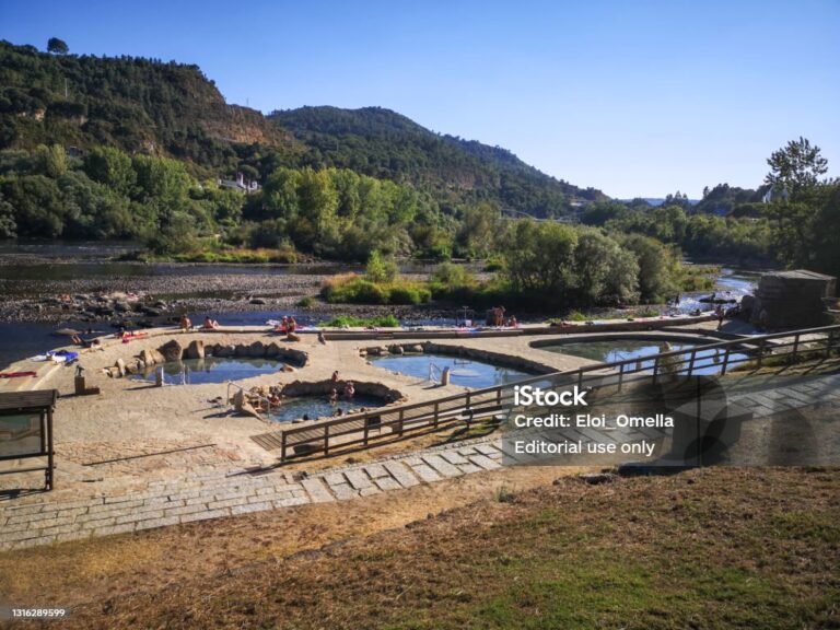 August 5, 2020 - Ourense, Spain: People taking a thermal bath in the open to pubilc Termas do Muíño da Veiga near Miño river